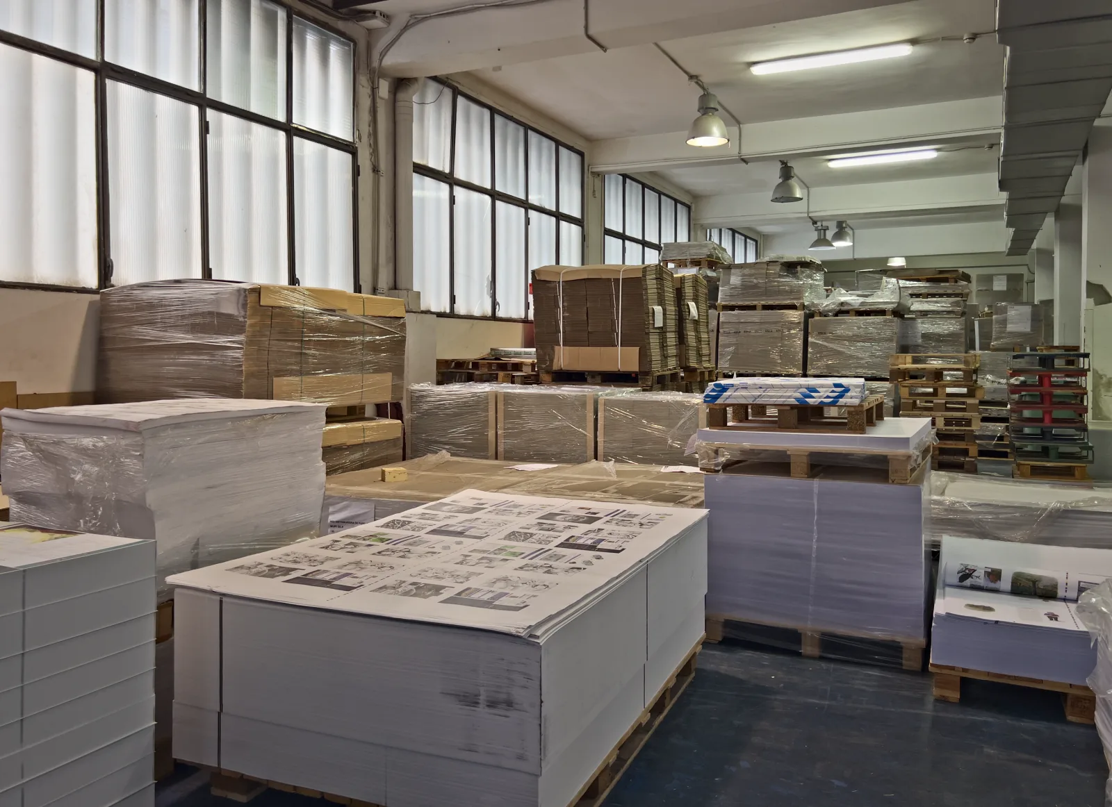 Magatzem amb caixes de cartró i piles de paper preparades